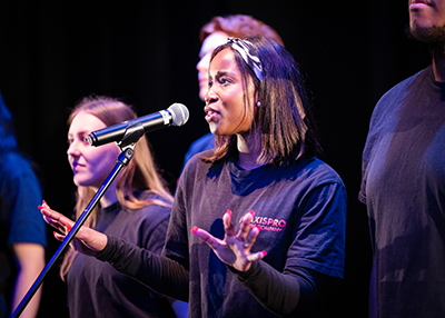Praxis Performing Arts Students on stage performing at HRUC MIT launch.